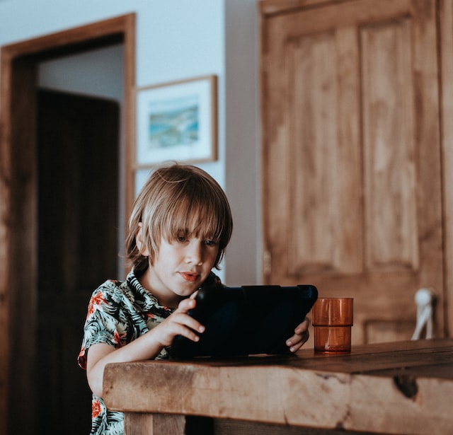 young boy using ipad young boy using ipad